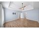 Bright bedroom with hardwood floors, tray ceiling, ceiling fan, and lots of natural light at 305 Corrigan Trce, Peachtree City, GA 30269