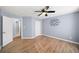 Primary bedroom with blue walls, wood floors, and en suite bathroom at 305 Corrigan Trce, Peachtree City, GA 30269