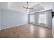 Spacious bedroom with hardwood floors, tray ceiling, ceiling fan, and lots of natural light at 305 Corrigan Trce, Peachtree City, GA 30269