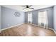 Light filled bedroom with modern wall decor, wood floors, and large windows at 305 Corrigan Trce, Peachtree City, GA 30269