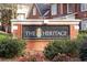 Charming brick entrance sign for 'The Heritage' community with decorative pineapple emblem at 305 Corrigan Trce, Peachtree City, GA 30269