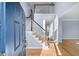 Bright foyer featuring a staircase with hardwood floors and a soaring ceiling at 305 Corrigan Trce, Peachtree City, GA 30269
