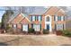 Two-story brick home with blue shutters and well-manicured landscaping at 305 Corrigan Trce, Peachtree City, GA 30269