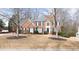 Traditional brick home with blue shutters and mature trees in a quiet neighborhood at 305 Corrigan Trce, Peachtree City, GA 30269