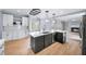 Stylish kitchen with stainless steel appliances, island with dark cabinets, and open layout at 305 Corrigan Trce, Peachtree City, GA 30269