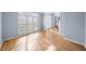 Sun-filled living room featuring hardwood floors, large window, and natural light at 305 Corrigan Trce, Peachtree City, GA 30269