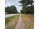 Residential street scene showing sidewalk and trees at 3499 New Macland Rd, Powder Springs, GA 30127