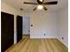 Bedroom with light walls, wood floors, and two doors at 684 Tarkington Rd, Stone Mountain, GA 30088