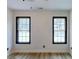 Spacious bedroom with two windows and ceiling fan at 684 Tarkington Rd, Stone Mountain, GA 30088