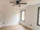 Bright bedroom featuring hardwood floors and ceiling fan at 684 Tarkington Rd, Stone Mountain, GA 30088