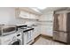 Basement kitchen with stainless steel fridge and white cabinets at 769 Penn Ne Ave, Atlanta, GA 30308