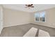 Large bedroom with window, ceiling fan and carpet at 1209 Westgate Dr, Lilburn, GA 30047