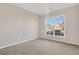 Bright bedroom with large window and neutral carpeting at 1209 Westgate Dr, Lilburn, GA 30047