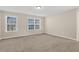 Well-lit bedroom with neutral walls and carpet at 1209 Westgate Dr, Lilburn, GA 30047