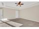 Spacious bedroom with ceiling fan and carpet at 1209 Westgate Dr, Lilburn, GA 30047