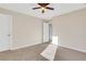 Well-lit bedroom with ceiling fan and access to hallway at 1209 Westgate Dr, Lilburn, GA 30047