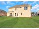 Two-story house with beige siding and a large backyard at 1209 Westgate Dr, Lilburn, GA 30047