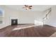 Spacious living room with hardwood floors, fireplace and staircase at 1209 Westgate Dr, Lilburn, GA 30047