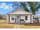 Charming white cottage with a covered porch and landscaped yard at 363 Roselane Nw St, Marietta, GA 30060