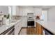 Modern kitchen with white cabinets, quartz countertops and hardwood floors at 363 Roselane Nw St, Marietta, GA 30060