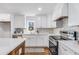 Modern kitchen features white cabinets, stainless steel appliances, and hardwood floors at 363 Roselane Nw St, Marietta, GA 30060