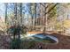 Neglected above ground pool in a wooded backyard at 390 Wayside Dr, Lawrenceville, GA 30046