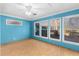 Blue bedroom with light wood flooring, ceiling fan and window at 390 Wayside Dr, Lawrenceville, GA 30046