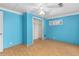 Blue bedroom with light wood flooring, ceiling fan and closet at 390 Wayside Dr, Lawrenceville, GA 30046