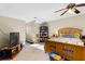 Spacious bedroom with wood bed frame and ceiling fan at 390 Wayside Dr, Lawrenceville, GA 30046