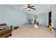 Spacious bedroom with light blue walls and ceiling fan at 390 Wayside Dr, Lawrenceville, GA 30046