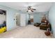 Spacious bedroom with light blue walls and ceiling fan at 390 Wayside Dr, Lawrenceville, GA 30046