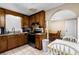 View of kitchen with wood cabinets, dining area, and stainless steel appliances at 390 Wayside Dr, Lawrenceville, GA 30046