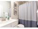 Clean bathroom, shower, white vanity, and framed artwork at 830 Corsiglia, Marietta, GA 30060