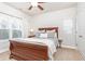 Bright bedroom with a wooden sleigh bed, window, and neutral wall colors at 830 Corsiglia, Marietta, GA 30060