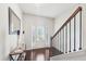 Bright entryway with hardwood floors, console table, and staircase at 102 Freedom Dr, Acworth, GA 30102