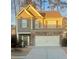 Two-story house with stone accents and a two-car garage at 102 Freedom Dr, Acworth, GA 30102