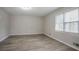 Bright bedroom with wood-look floors and large windows at 2026 Morris Dr, Riverdale, GA 30296