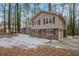 Two-story home with partial brick exterior and snow covered yard at 2026 Morris Dr, Riverdale, GA 30296