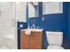 Modern bathroom with blue walls, walk-in shower, and floating vanity at 2295 Cloverdale Se Dr, Atlanta, GA 30316