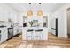 Bright kitchen boasts white cabinetry, quartz countertops, and an island with seating at 330 Mount Zion Rd, Hapeville, GA 30354