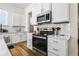 Bright kitchen boasts white cabinets, stainless steel appliances, and white subway tile at 330 Mount Zion Rd, Hapeville, GA 30354