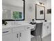 Double vanity bathroom with a large mirror and modern lighting at 399 Tillman Pass, Woodstock, GA 30188