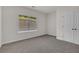 Bright bedroom with gray carpet, window, and closet at 399 Tillman Pass, Woodstock, GA 30188