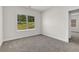 Simple bedroom with gray carpet, window, and access to another room at 399 Tillman Pass, Woodstock, GA 30188