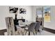 Dining area with glass table, modern chairs, and dark hardwood floors at 399 Tillman Pass, Woodstock, GA 30188