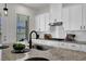 Modern kitchen with granite countertops and white cabinets at 399 Tillman Pass, Woodstock, GA 30188