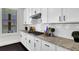 White cabinets and granite countertops in this kitchen at 399 Tillman Pass, Woodstock, GA 30188