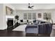 Living area with dark hardwood floors, sectional sofa, fireplace, and large windows at 399 Tillman Pass, Woodstock, GA 30188