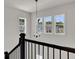 Elegant staircase with a chandelier and views of the backyard at 399 Tillman Pass, Woodstock, GA 30188