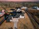 Aerial view of a farmhouse community with a paved driveway and large lots at 5180 Howard Rd, Cumming, GA 30040